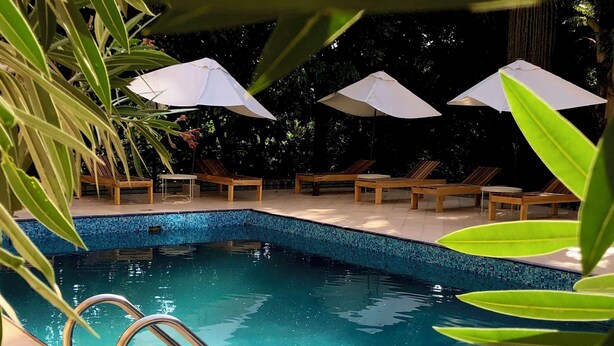 A swimming pool with clear blue water, surrounded by lounge chairs and umbrellas. - The address resort (Bugala Island)