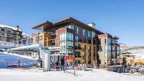 A multi-story hotel with a modern architectural design, featuring large windows and a mix of brick and glass facades.