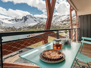 Enjoy a peaceful meal on the balcony with a breathtaking view of the surrounding mountains and water.