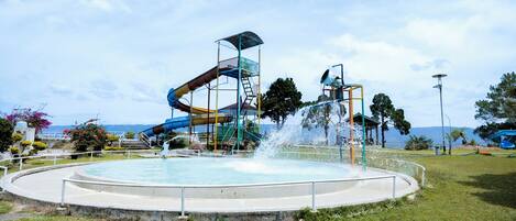 A water park with multiple slides and a central fountain.