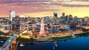 A cityscape with a prominent building, a river, and a bridge.