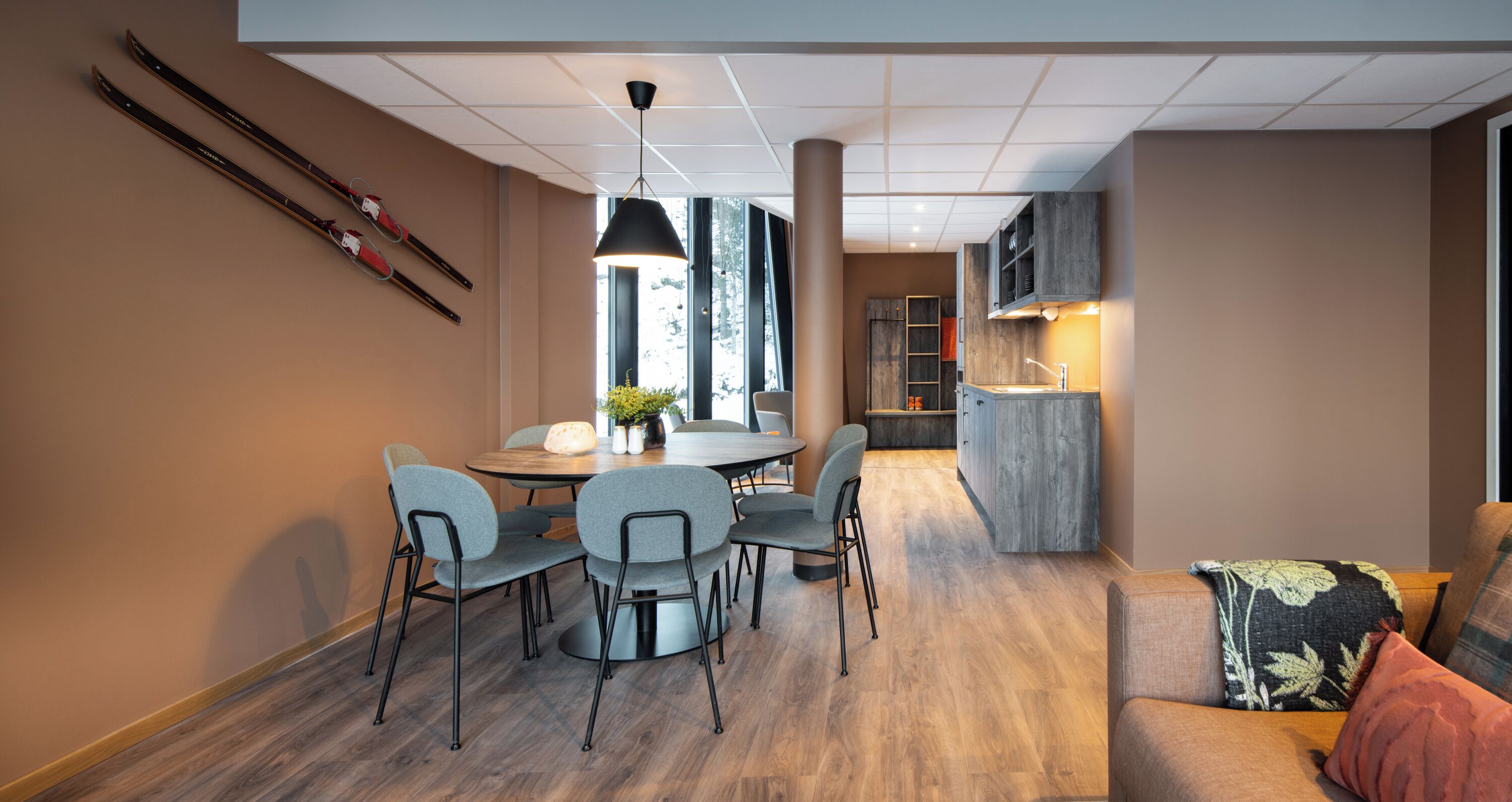 A modern interior with a dining area, kitchen, and seating space.