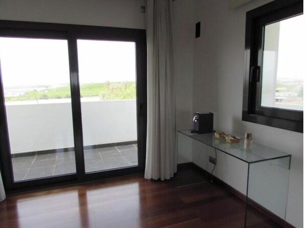 Enjoy the serene atmosphere and expansive views from the outdoor terrace, accessible through the large sliding glass door.
