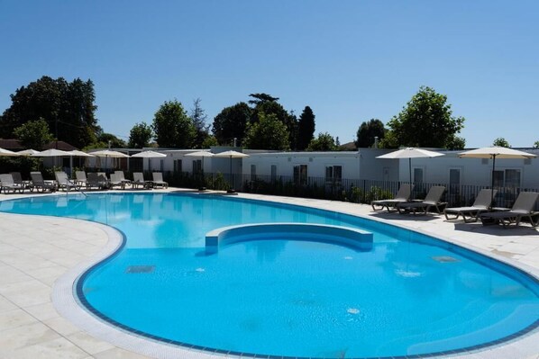 Seasonal outdoor pool, pool umbrellas, sun loungers