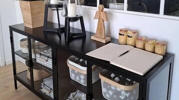 A modern kitchen with white cabinets, a black countertop, and a large window.