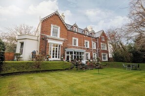 A large brick house with a spacious front yard, a conservatory, and a well-maintained garden. - Mossley Hill Retreat (Liverpool)