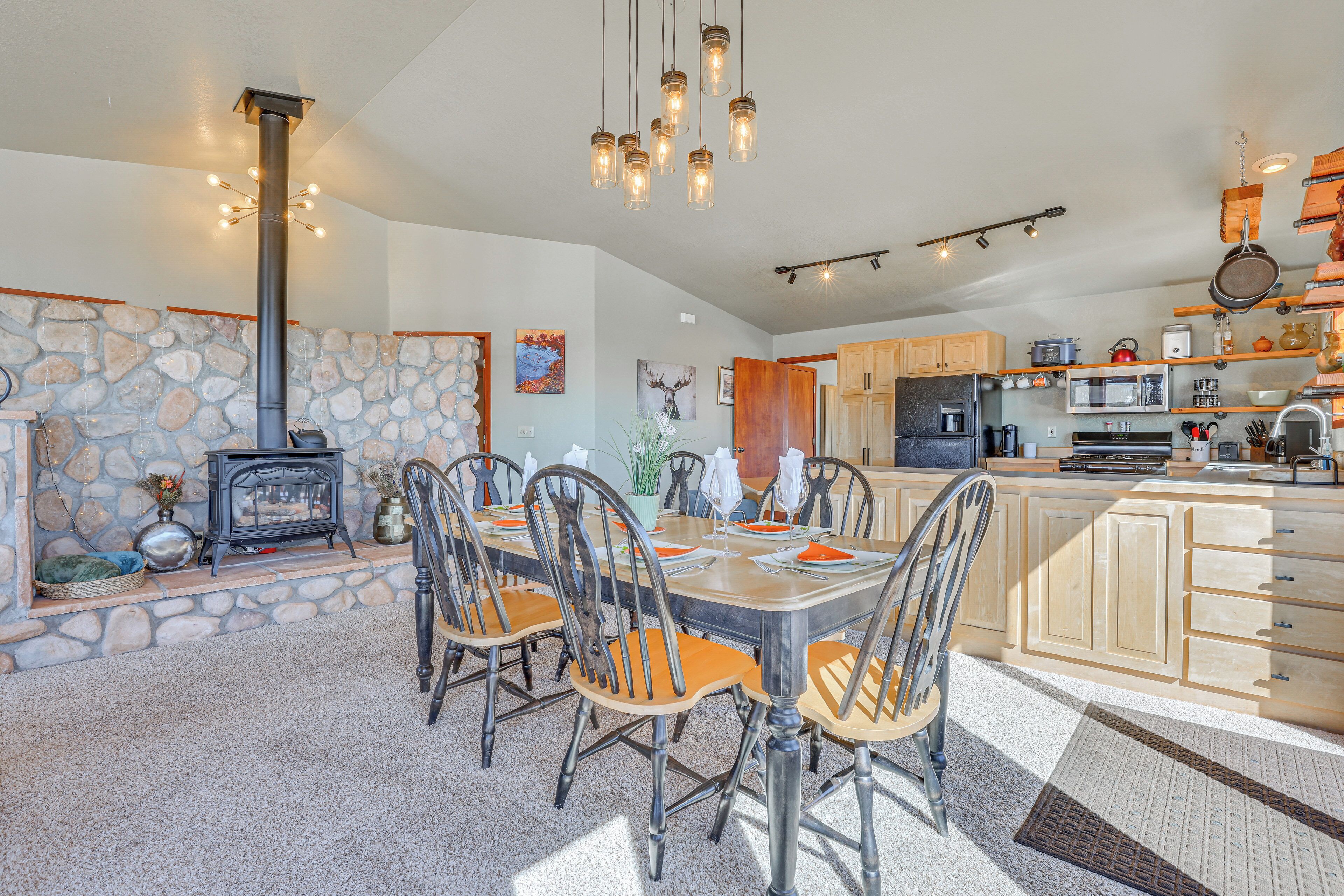 A spacious kitchen with a stone wall, wooden cabinets, and a central island.