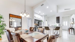 A modern dining area with a wooden table, leather chairs, and a glass-top dining table. - Near Golf & Wdw: Family-friendly Home in Davenport (Davenport)