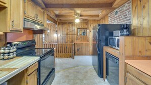 A wooden kitchen with a stove, oven, refrigerator, and microwave. - Riverfront Baldwinsville Apartment w/ Shared Deck! (Baldwinsville)