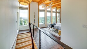 A bedroom with a bed, a window, and a view of the outdoors. - Mid-century Escape: Lake Views, Steps to Cave Bay! (Worley)