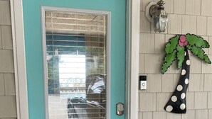 A turquoise door with a glass panel, a keypad lock, and a small mailbox. - NEW LISTING: Breathtaking Waterfront Views w/ Private Dock  (Kill Devil Hills)