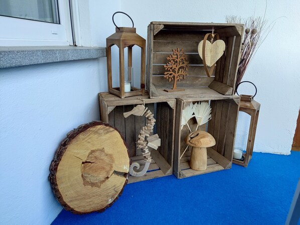 Decorative items adorn the wall, featuring a lantern, wooden box, and tree branch.
