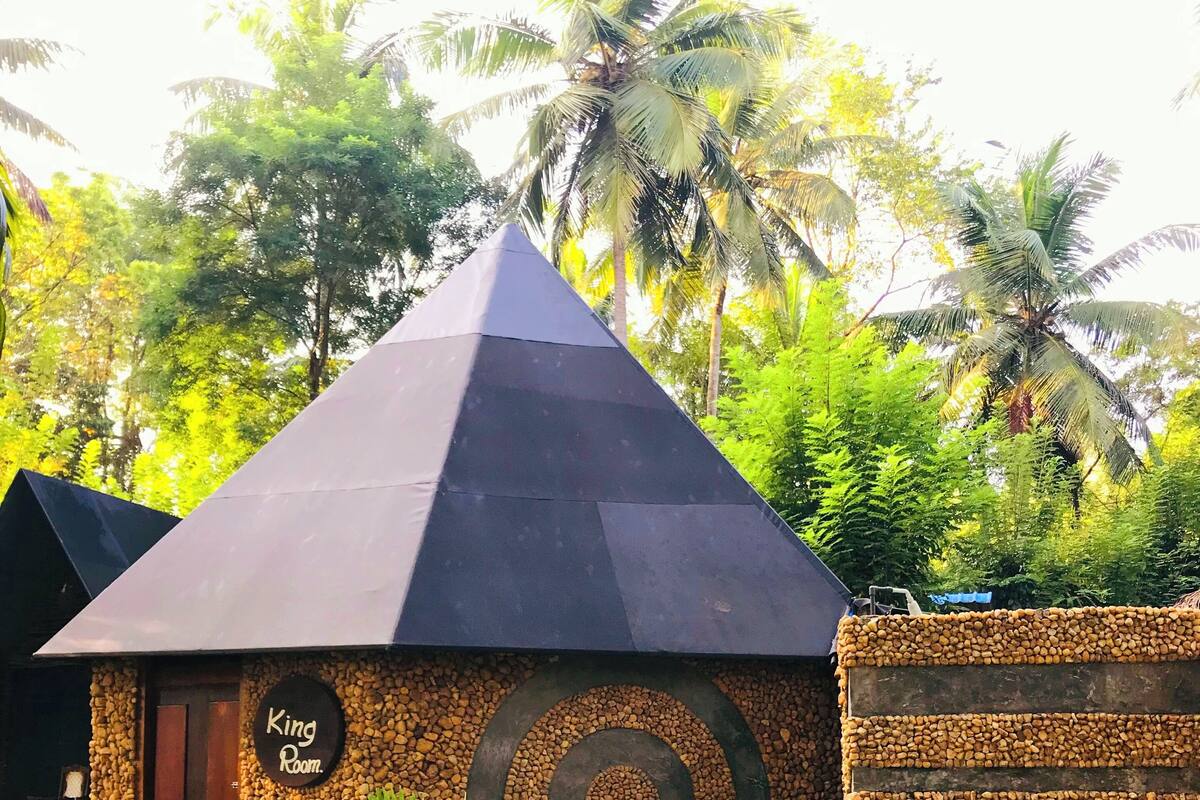 A small, stone building with a pyramid-shaped roof and a sign reading "King Room."