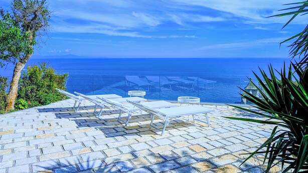 A terrace with outdoor seating and a view of the sea. - Perfect destination for families and friends, nestled between seas and mountains (Praiano)