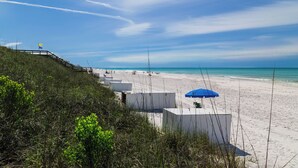 A beach with white sand, a wooden walkway, and a blue umbrella. - SOUTH OF 30A~Walk to beach~4 Bikes!POOL! Sleeps 10 (Santa Rosa Beach)