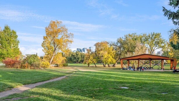 A park with a pavilion, grassy areas, and trees.