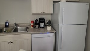 A kitchen with a dishwasher, a coffee maker, and a refrigerator. - Amazing 2 Bedroom  Suites. Very cozy and pet-friedly  (Saskatoon)