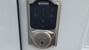 A door with a numeric keypad and a keyhole. - Amazing 2 Bedroom  Suites. Very cozy and pet-friedly  (Saskatoon)