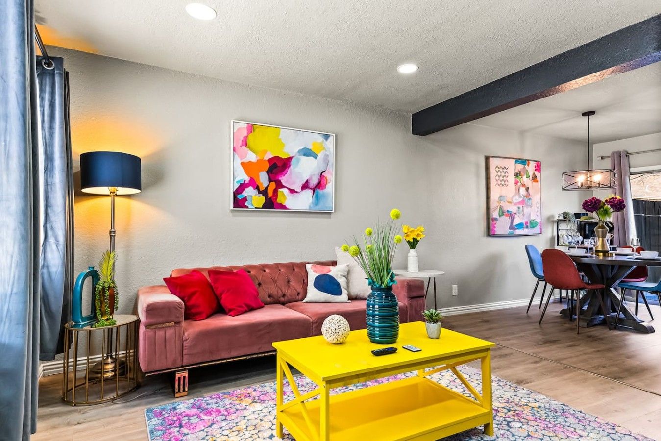 A modern living room with a sofa, coffee table, and artwork on the walls.