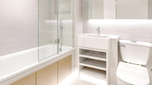 A modern bathroom with a glass-enclosed shower, a white sink, and a toilet. - Amazing Place by Liverpool St Station (London)