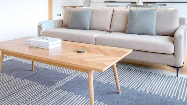 A modern living room with a sofa, a coffee table, and a patterned rug. - Amazing Place by Liverpool St Station (London)