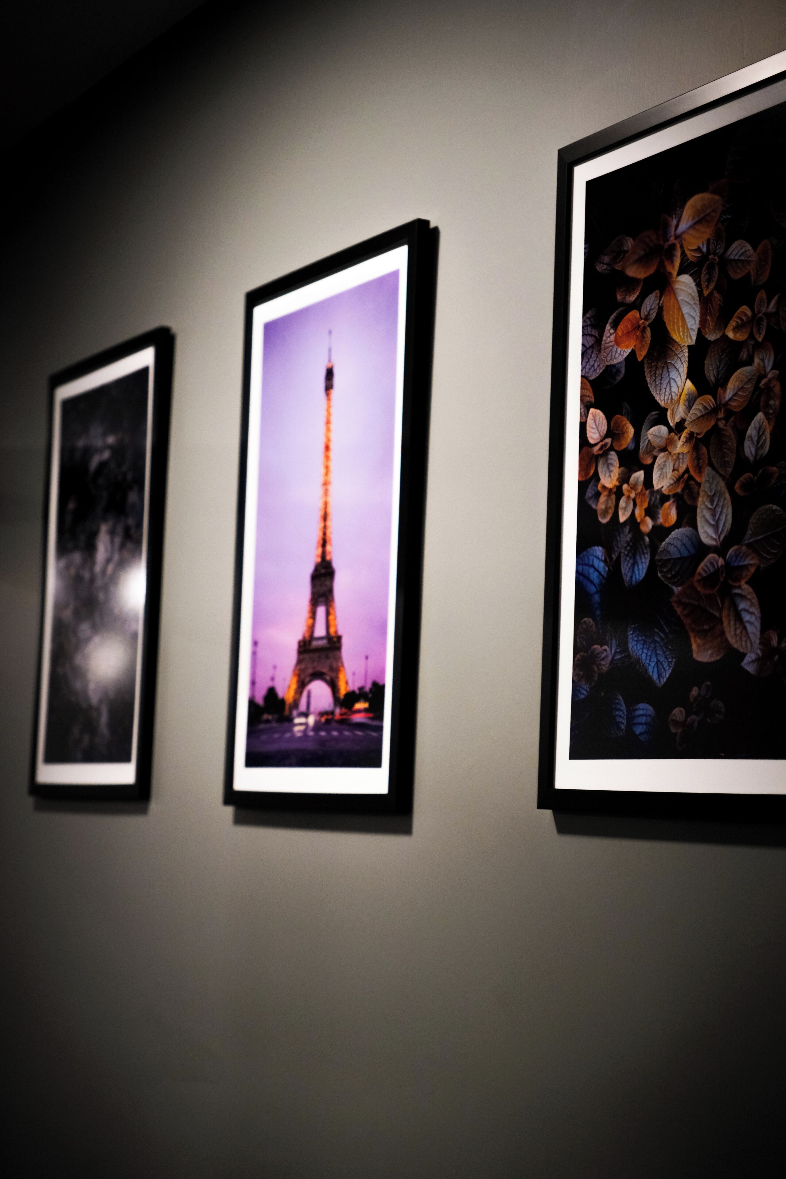 Three framed pictures on a wall.