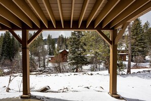 A wooden gazebo with a view of a cabin in a snowy landscape. - Comfortable 2 Bedroom Townhome  | Ski in/Ski Out (Tamarack)
