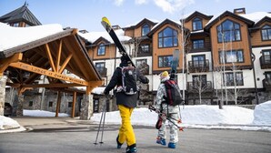 A lodge with a wooden facade, multiple balconies, and a sign reading "The Lodge at Osprey Meadows." - Beautiful Townhome|Private Hot Tub, Wood Fireplace (Tamarack)