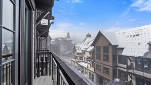 A view from a balcony overlooking a historic town with traditional architecture and snow-covered rooftops. - Gorgeous Condo|Juliette Balcony|Mountain & Village Views (Tamarack)