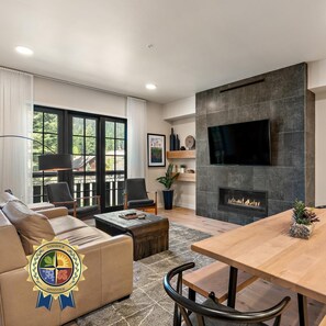 Una sala de estar moderna con chimenea, televisor de pantalla plana y asientos cómodos.