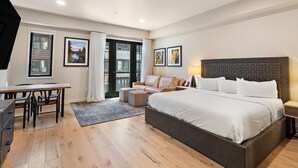 A modern bedroom with a large bed, a desk, and a sofa. - Hop, Skip, & a Jump|Includes Two 1-Day Lift Tickets (Tamarack)