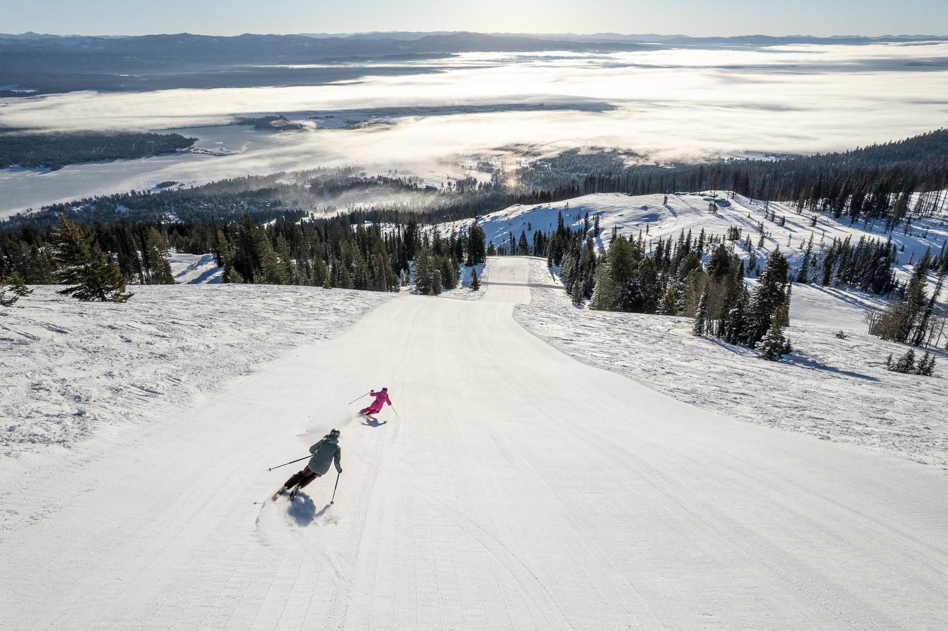 A ski slope with skiers descending.