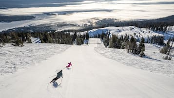 A ski slope with skiers descending.