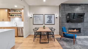 A modern kitchen with wooden cabinets, a stainless steel dishwasher, and a marble countertop.
