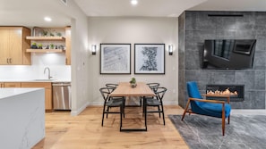 A modern kitchen with wooden cabinets, a stainless steel dishwasher, and a marble countertop. - Mountain Condo | Includes Two 1-Day Lift Tickets (Tamarack)