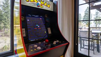 A Pac-Man arcade machine with a game screen, joystick, and score display.
