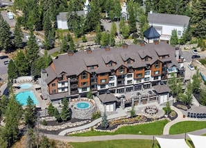 A multi-story lodge with a pool, outdoor seating, and a landscaped garden. - Cloudline | Includes Two 1-Day Lift Tickets (Tamarack)
