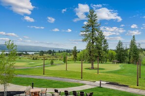 A golf course with a clear sky, a pond, and a gazebo. - Lake View Retreat|Exclusive Tamarack Perks (Tamarack)