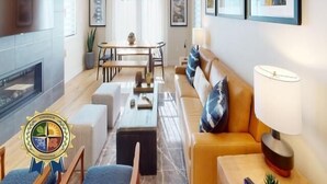 Una sala de estar moderna con chimenea, un sofá, una mesa de centro y un comedor con una mesa y sillas.