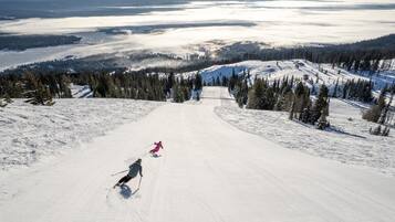 A ski slope with skiers descending.