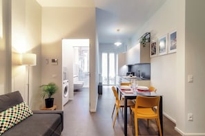 A modern apartment with a living area, dining space, and a kitchen. - Luci A Lago (Como)