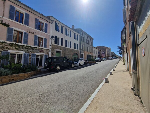 A street with parked cars and buildings.