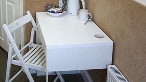 A small white table with a white chair, a white coffee pot, and a white mug on it. - Accommodation London Bridge (London)