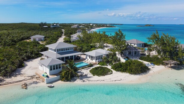 A beachfront property with multiple buildings, a swimming pool, and a clear view of the ocean. - BEACHFRONT! Best Location on Private Lazy River Sand Bar.  Always Calm Water! (Moore Hill)