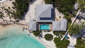 An aerial view of a beachfront property with a swimming pool, lounge chairs, and a beach area. - BEACHFRONT! Best Location on Private Lazy River Sand Bar.  Always Calm Water! (Moore Hill)