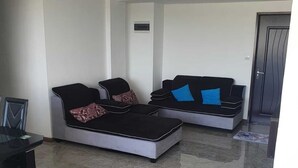 A modern living room with a black sofa set, a coffee table, and a small dining table. - Peaceful and beautiful space to spend quality time
close to beach  (Flic en Flac)