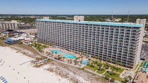 A high-rise hotel with multiple balconies, a pool area, and a beachside location. - Mariners Retreat High Rise Beach Living in Pcb! (Panama City Beach)