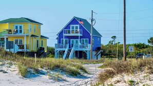 A two-story beach house with a balcony and a flag. - A Wave From it All - 3BR Beachside Coastal Retreat (Gulf Shores)