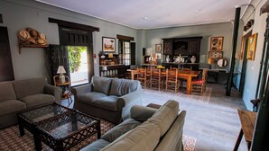 A spacious living area with a sofa set, a coffee table, and a dining table with chairs. - HN Romero 18 (Almonte)