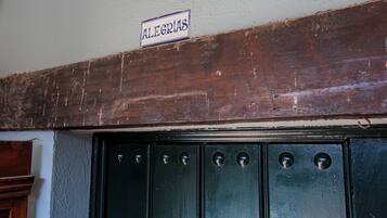 A wooden door with a sign above it that reads "ALEGRIAS."